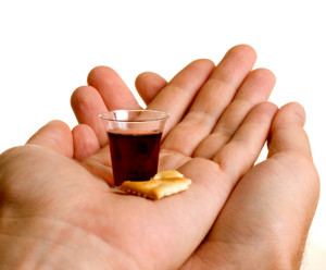 Hands held together recieving communion at a modern church